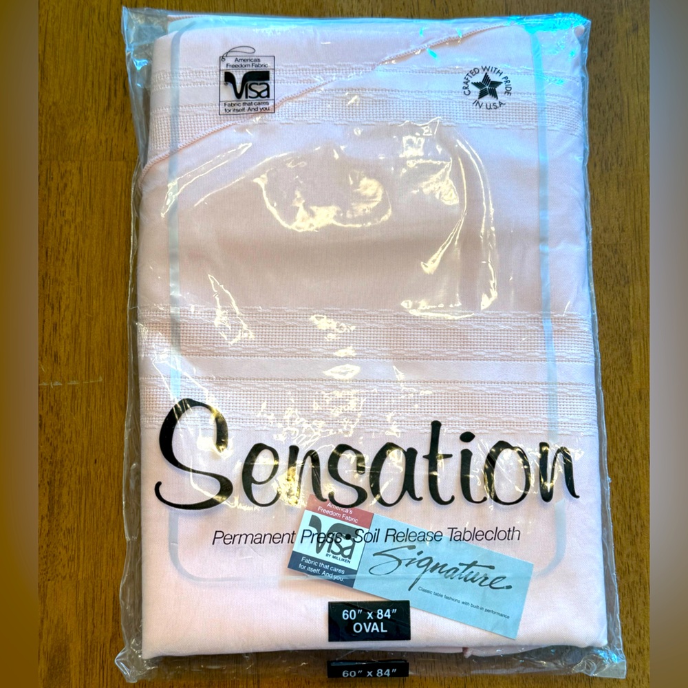 Peach Blush 60” x 84” Oval Tablecloth. 100% Polyester. New never opened.